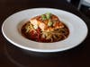 Miso-dashi salmon with pan-fried noodles, stir-fry vegetables and miso-dashi broth at Acorn Grill + Terrace.