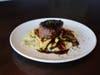 Top sirloin with roasted garlic mashed potatoes and red wine sauce at Acorn Grill + Terrace.