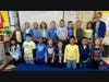 Students dressed in blue and yellow, which are the school colors of St. Francis Xavier Catholic School.  