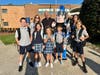 Dr. Alday-Engelman, Mrs. Huizinga, Fr. Dindo Billote, and students pictured with the Titan.  