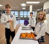 8th grade students making lunches.  