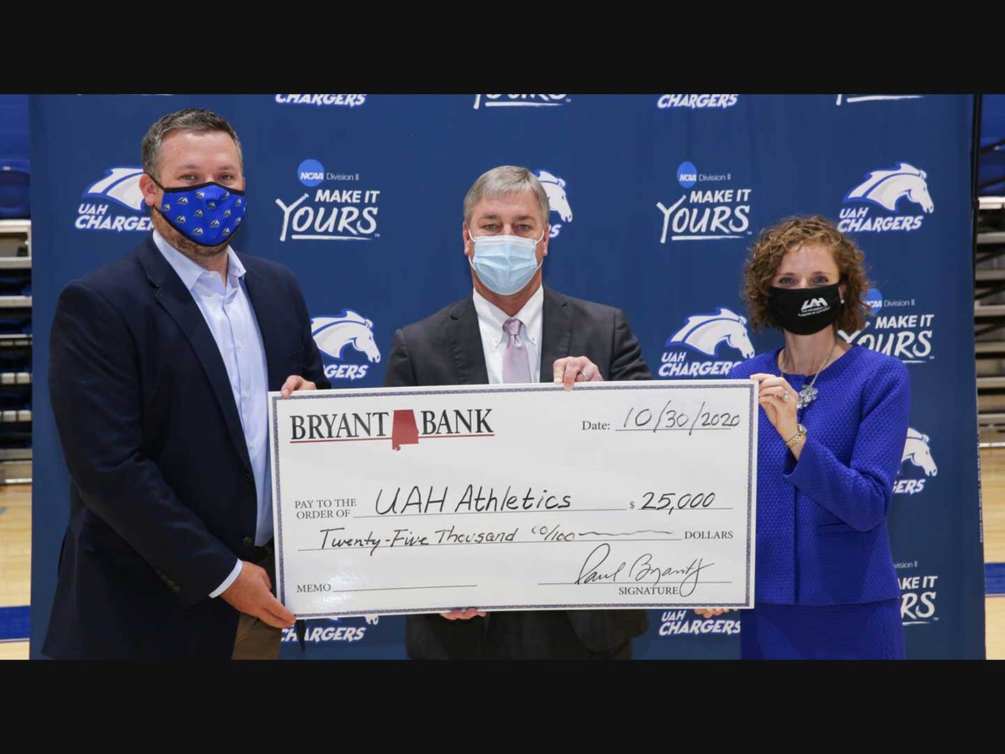 Ken Watson (center), President of Bryant Bank Huntsville presents a $25,000 gift to UAH Athletics. It was accepted by Cade Smith, (left) Director of Intercollegiate Athletics and Mallie Hale (right), Vice President for University Advancement.