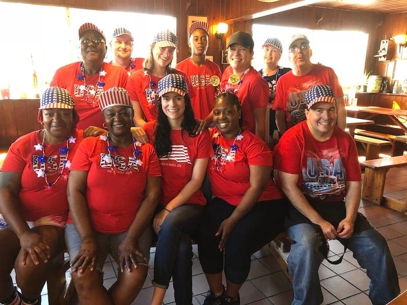 Traci Hughes poses with longtime staff members of Jimbo's Pit Bar-B-Q in Lakeland. The restaurant is struggling to find staff to reopen in the wake of the coronavirus pandemic.