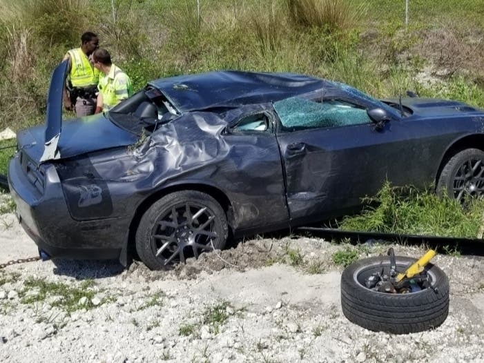 The driver's car started to spin as he raced another driver on the interstate, and it spun into another car. 