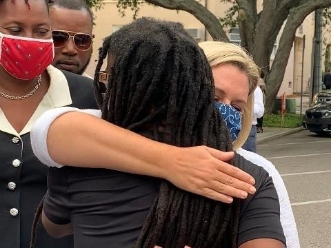 City leaders comfort a community member, Jabaar Edmond in St. Petersburg with hugs and listening to him on June 3 outside city hall. 