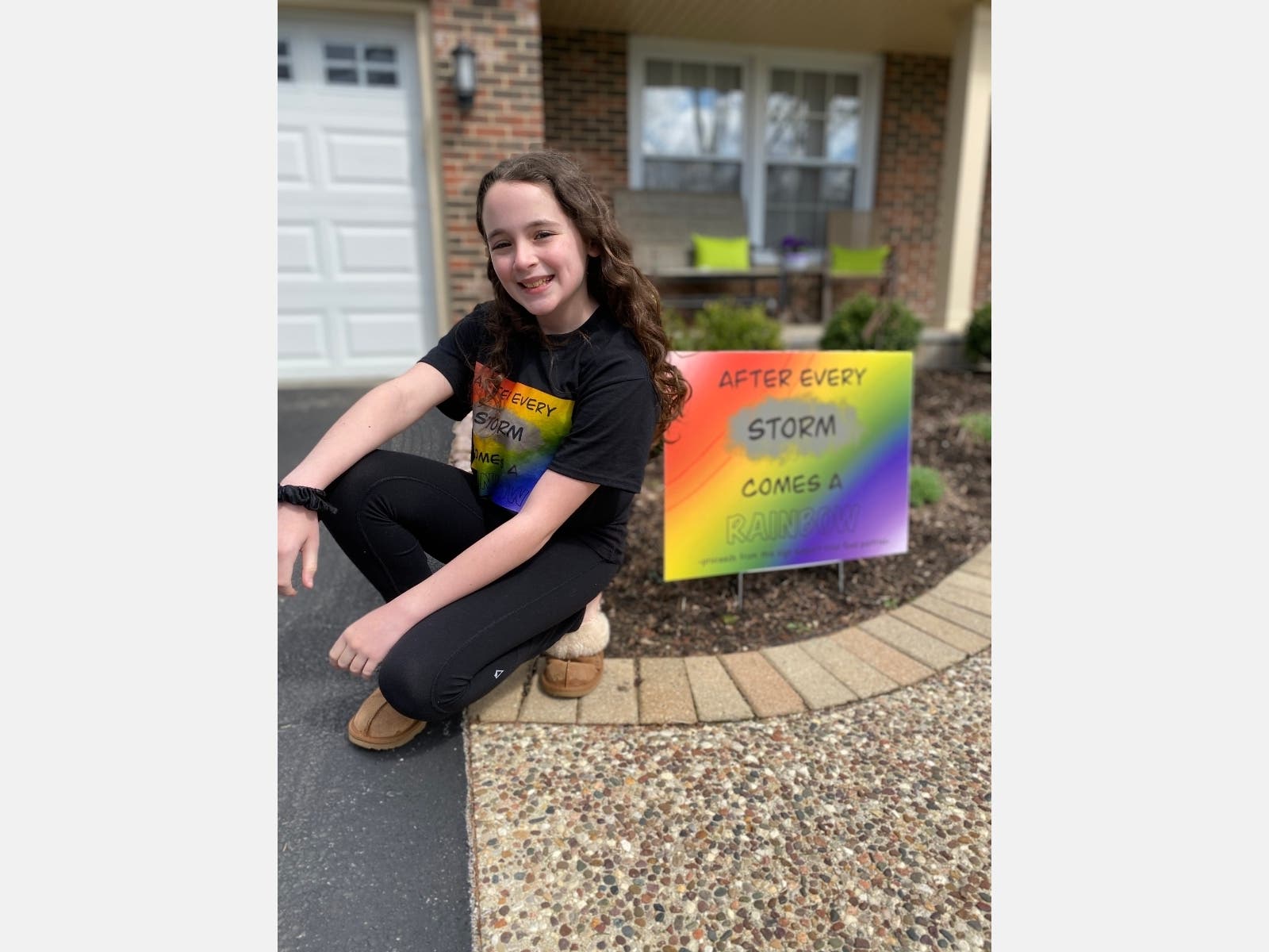 Deerfield's Meredith Rivkin sits by one of the rainbow signs she created. 