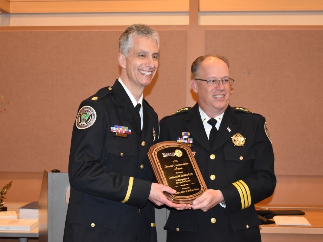 Commander Tom Reed (left) is presented an award by Buffalo Grove Police Chief Steve Casstevens.