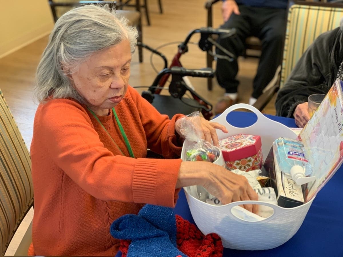 Resident Dora Villaflor puts together a care package at Glenview's Emerald Place. 