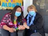 Aimee Fernandez (left), director of nursing, and Marcia Solvsberg enjoy the luau. 