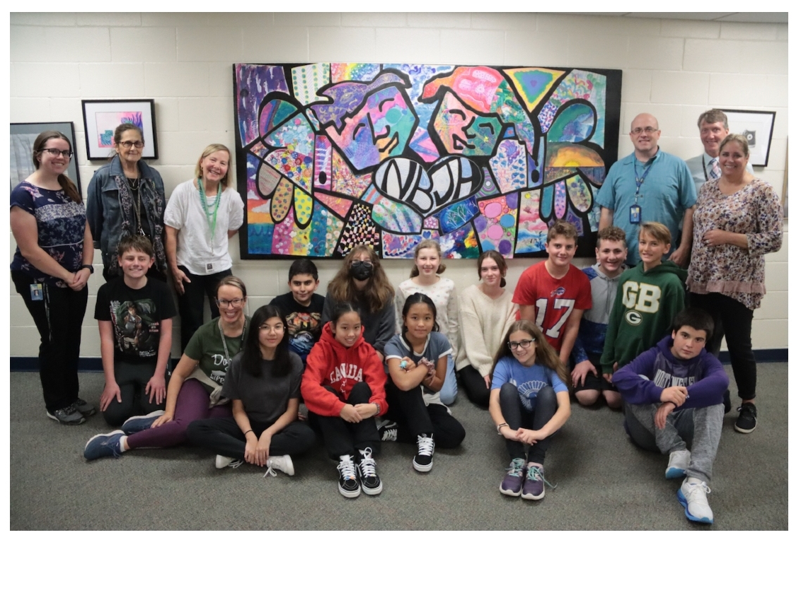 Members of the Northbrook Junior High Community Art Club gather around the mosaic mural they created as part of a partnership with the non-profit organization Twist Out Cancer.