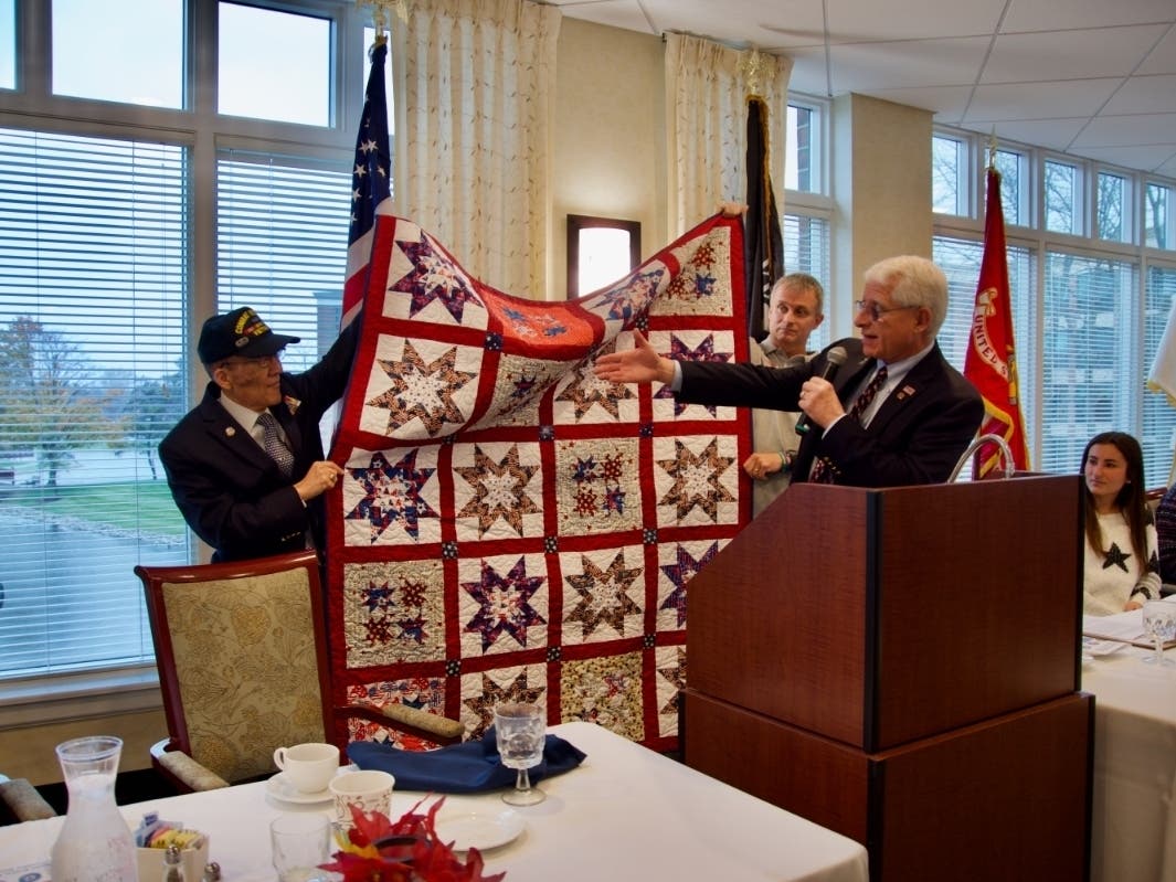 Greg Padovani (right), chairman of the Veterans Memorial Committee of Arlington Heights, speaks at the event.