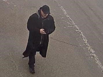 Surveillance footage from Walmart showed the subject to be white with short hair and a mustache, wearing a long black coat and black baseball cap. 