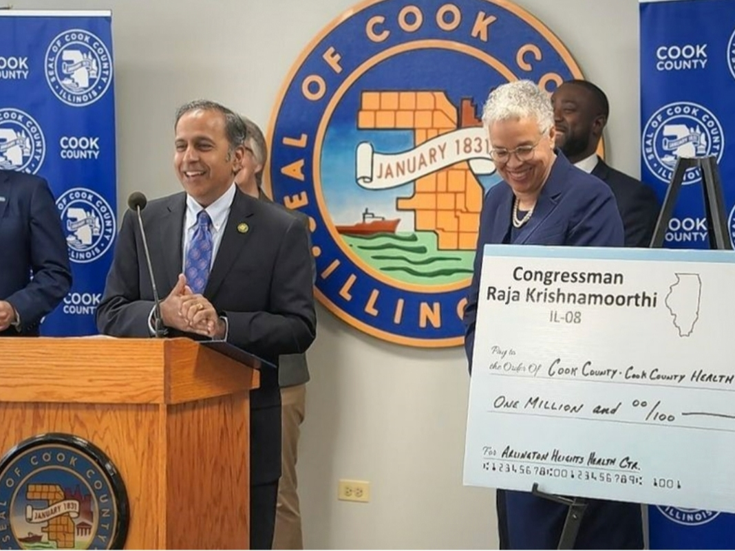 U.S. Rep. Raja Krishnamoorthi is flanked by Cook County Board President Toni Preckwinkle during a check presentation last week. 