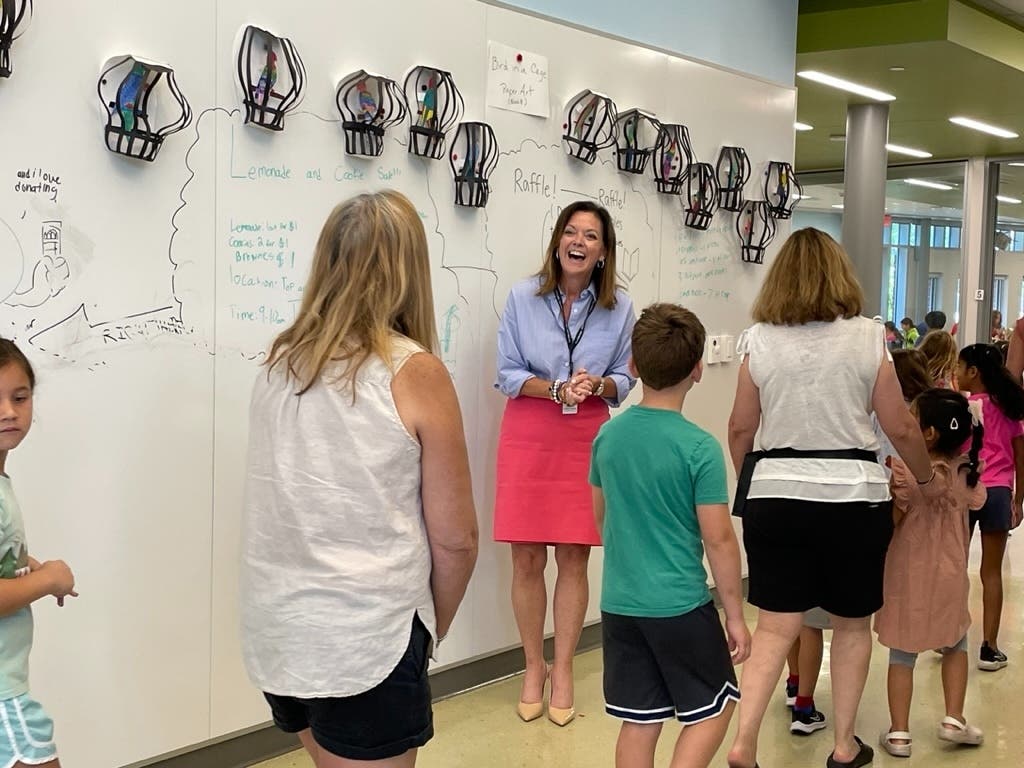 New Northbrook/Glenview School District 30 Superintendent Dr. Emily Tammaru greets students as they arrive for school this year at Maple School in Northbrook.