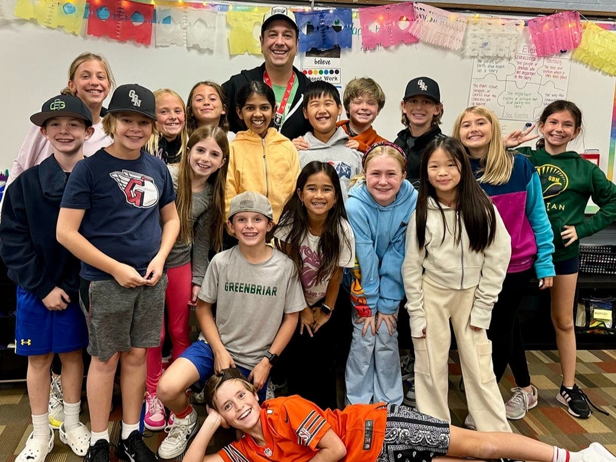 Jeremy Bartunek celebrates with one of his music classes at Greenbriar School. 