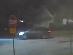 The dark-colored SUV seen here was driven by a suspect in the shooting and fled the scene. 