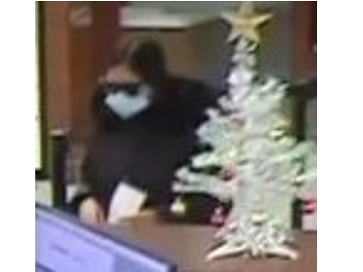 The woman, seen here in a surveillance image, left the bank on foot in an unknown direction. 