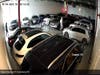 Two members of the group inspect cars in the showroom and attempt to start them. 
