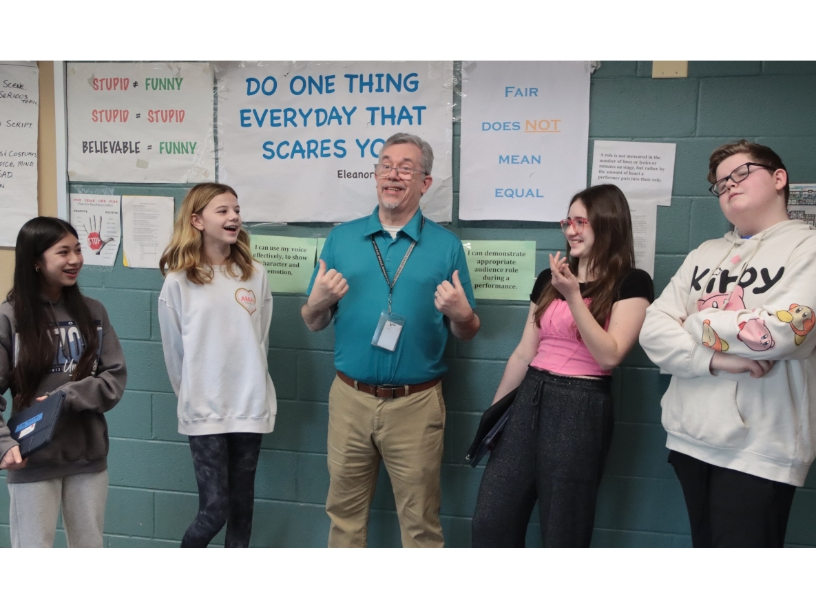 Drama students, from left, Janessa Wu, Jocelyn Cameron, Lexie Rentzelos and Jamie Early surround Northbrook Junior High School Drama Teacher David Downing to congratulate him on the award. 