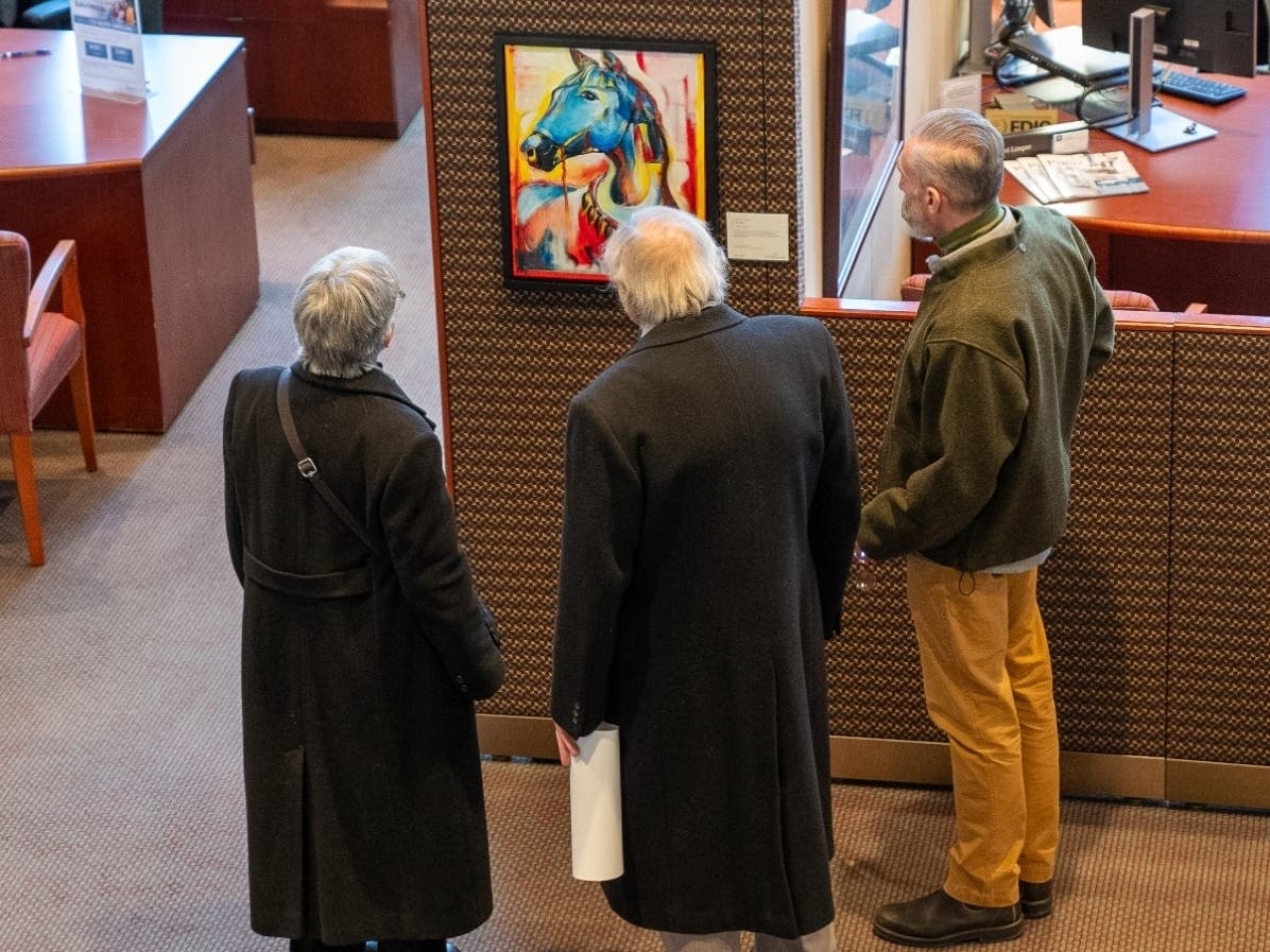 Attendees of the open house check out some art. 