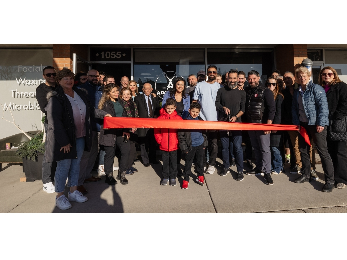 Members of the Glenview Chamber of Commerce join the staff at Adam and Co. Barbershop during a special ribbon-cutting ceremony. 