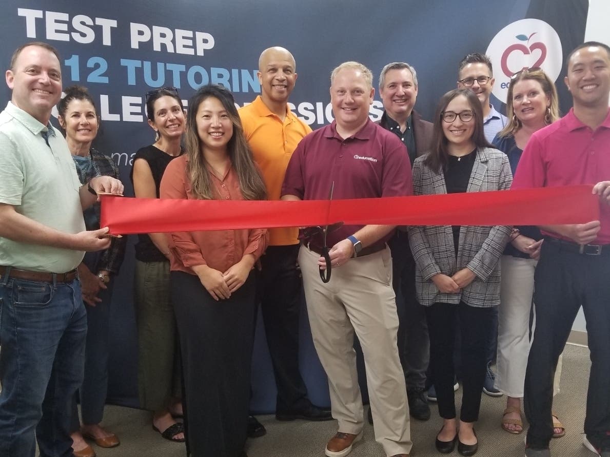 The staff of C2 Education North Shore meets with members of the Glenview Chamber of Commerce during a ribbon-cutting ceremony. 