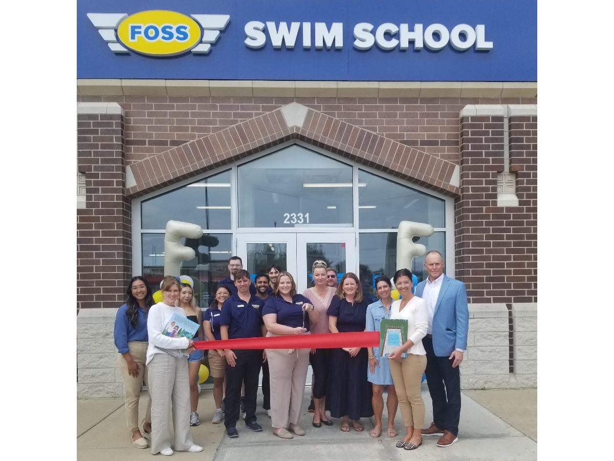 Members of the Glenview Chamber of Commerce celebrate a ribbon cutting at Foss Swim School. 