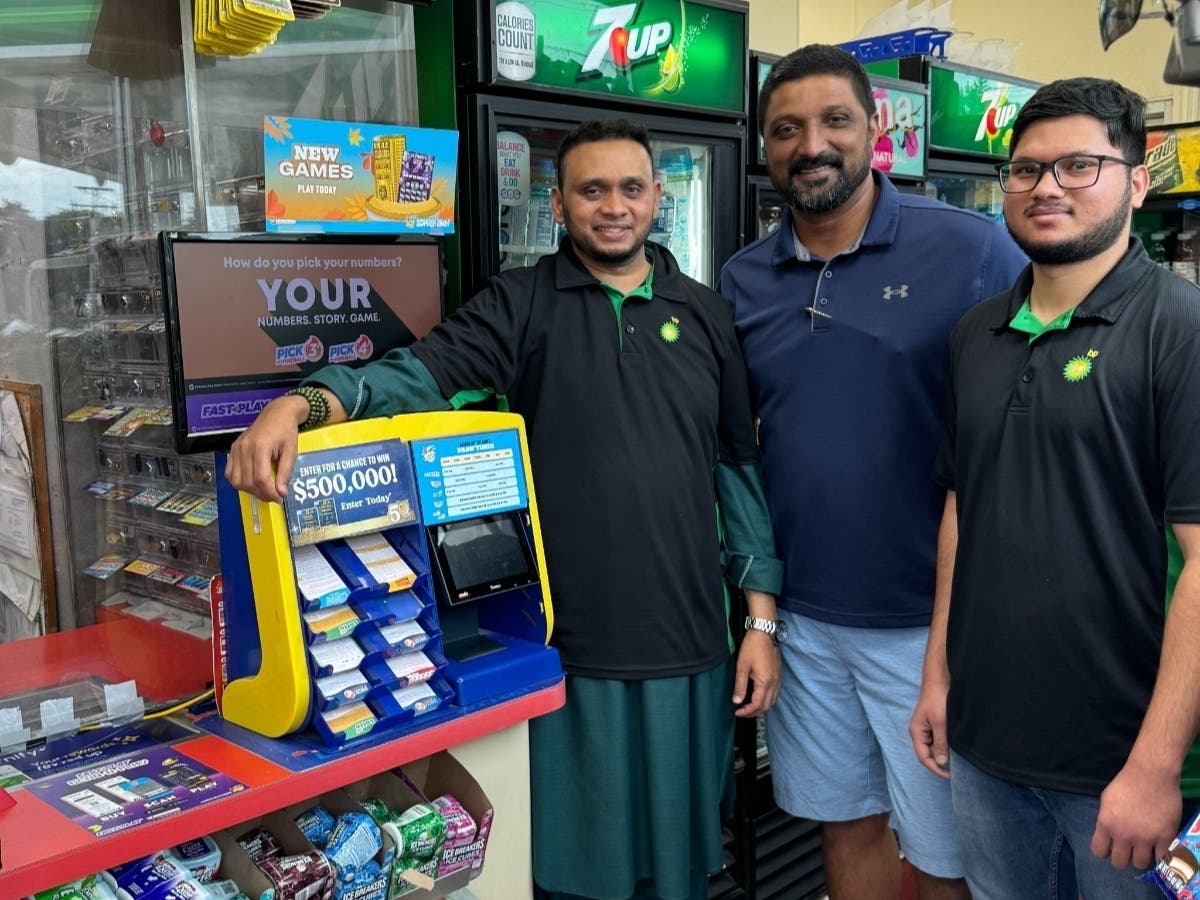 Febin Thomas, owner of a BP gas station in Des Plaines (middle), takes a celebratory photo with employees, Abdul Gaffar (left) and Muneeb Ahmed (right) after finding out they sold a $1.45 million winning Lucky Day Lotto ticket.