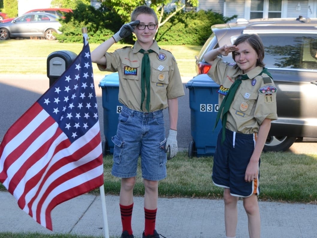 Al Benson sent in this photograph he took of two Boy Scouts from Blackhawk Troop 11 in Aurora retrieving a U.S. flag temporarily posted in an Aurora yard on National Flag Day. 