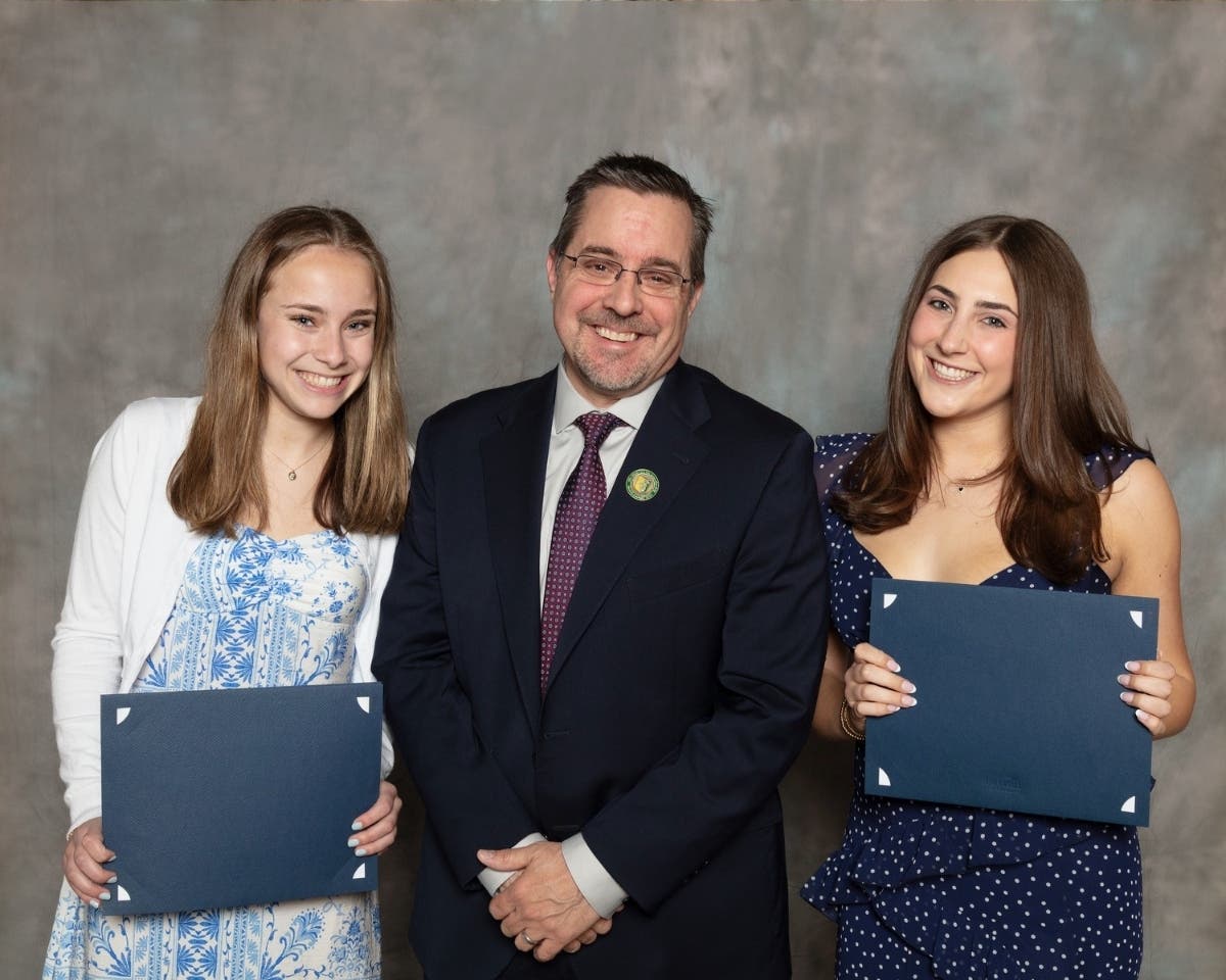 Emma Noll and Eva Weil are seen here with Greg Scapillato, D28 band director. 