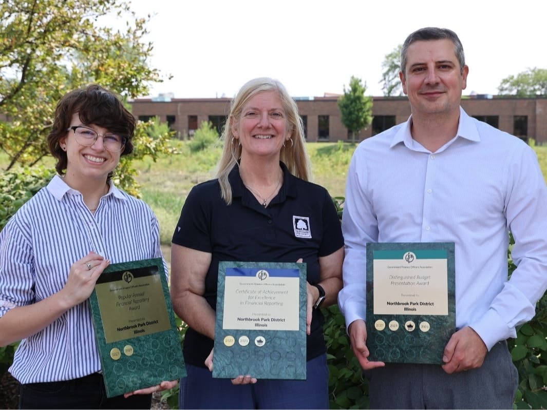 The Northbrook Park District's Graphic Design & Brand Specialist Claire Cinquegrani, left, Business Manager Ellen Drahos and Director of Finance and Technology Mike Tokar show off the three awards.