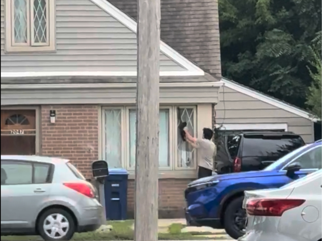 Ayham Babidi is shown in this third-party video attempting to gain access to his mother's home on Sept. 9 with an unplugged electric hedge trimmer.