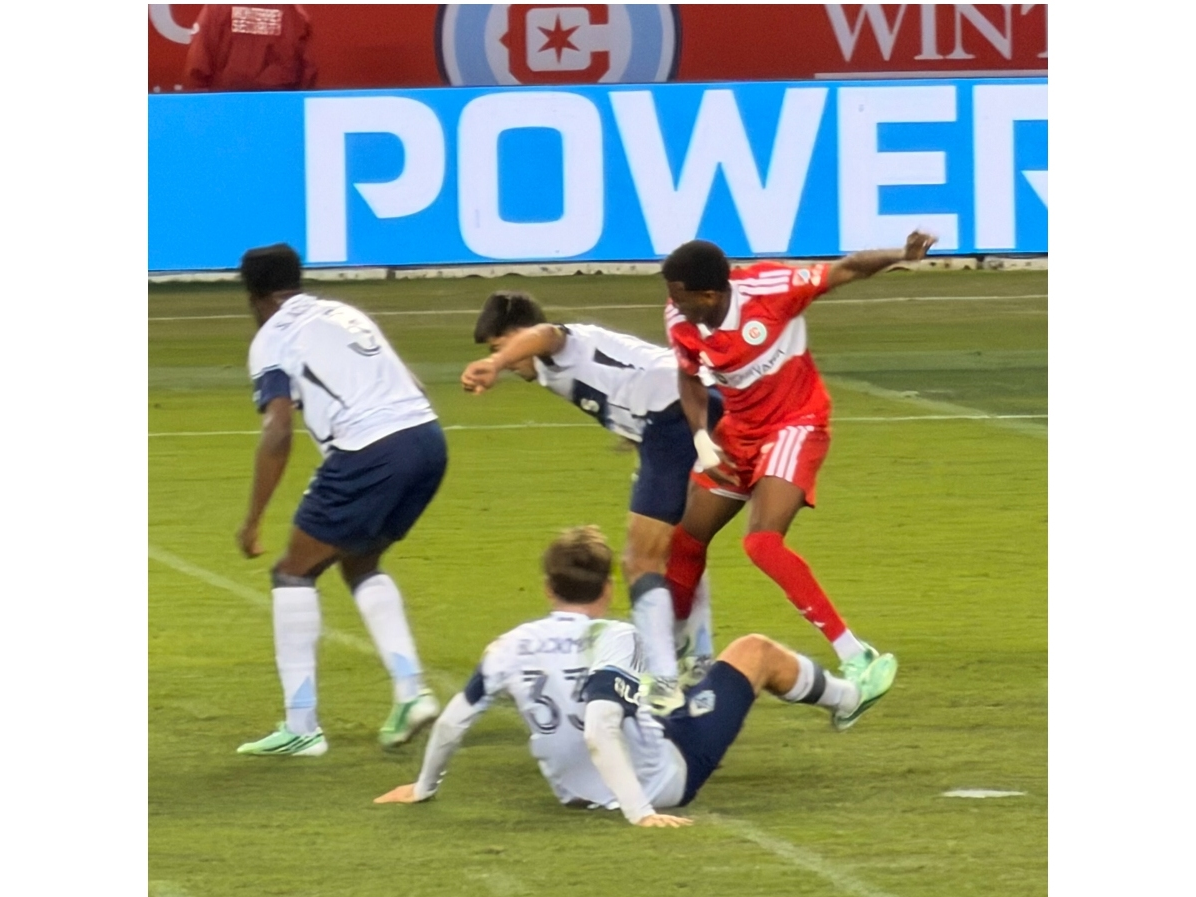 Chicago Fire forward Jonathan Bamba battles several Vancouver Whitecaps players Tuesday night in an MLS tilt at Soldier Field.