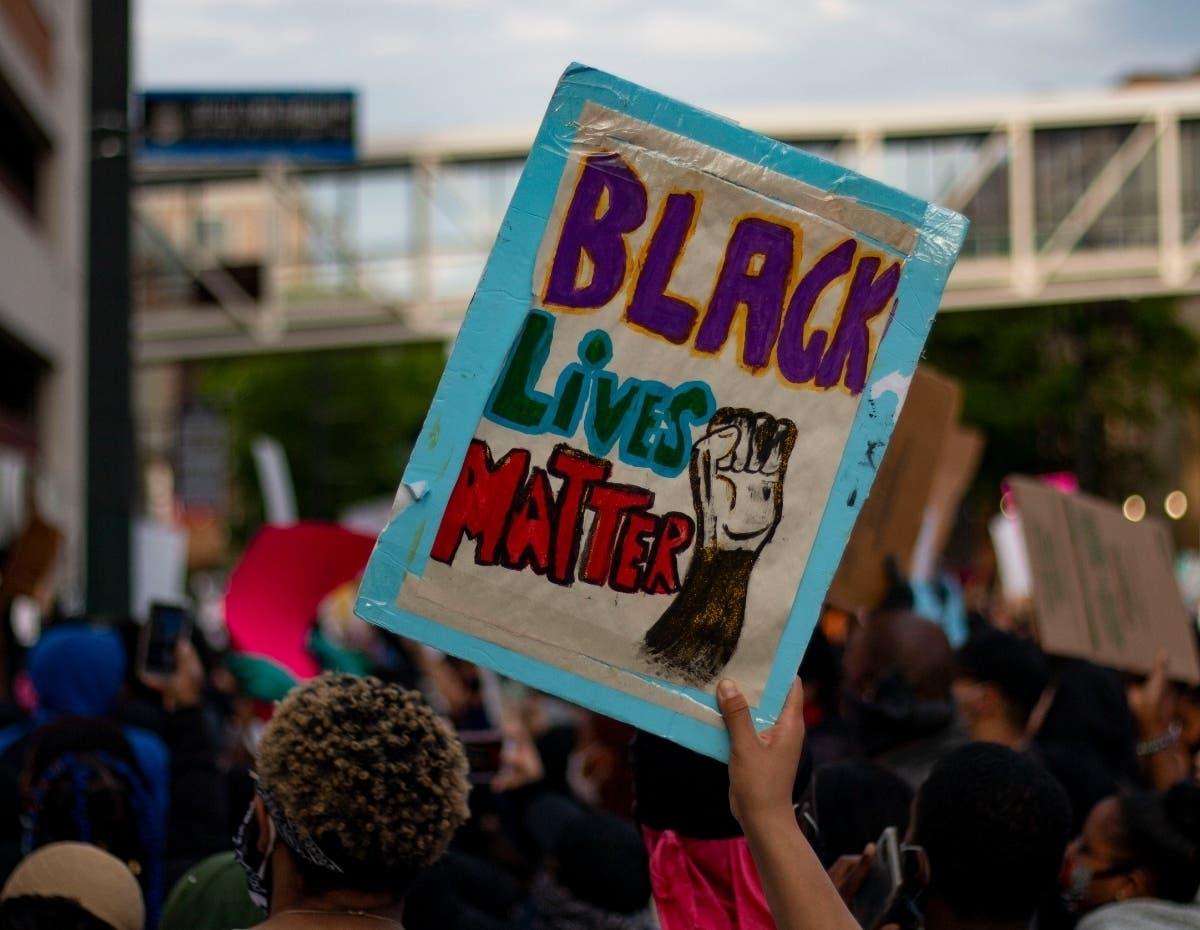 A protester in Paterson holds a sign as they march through the streets on Tuesday, June 2.