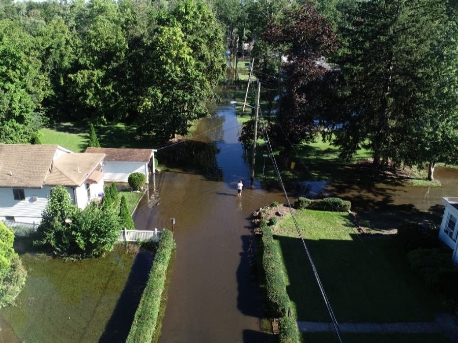 Ida brought heavy rains, raising river levels and causing flooding across the state. Pictured here, a man stands in a flooded street in the Crestview area of Wayne Township.