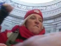 Photos included in a criminal complaint show Starer wearing red colored clothing, including a red hat with blue and white stripes with the word "Trump" and number 45 written on it, the Department of Justice said.