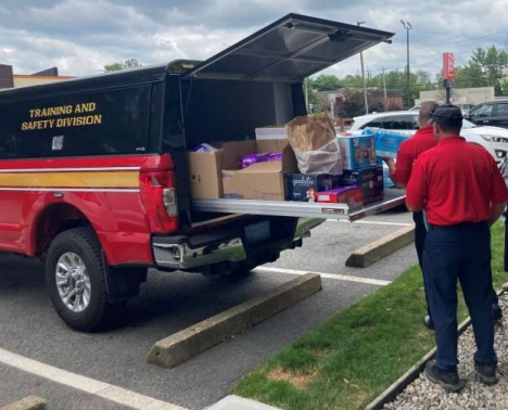 Donations are loaded into a Framingham Fire Department truck for asylum-seeking families on Friday.
