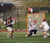 Junior attackman Conor Vickers puts one of his four goals past Greenwich goalie Jack Hamel 