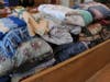 A pew is filled with donations at the St. Francis chapel.
