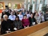Fr. Carmen Carlone, Pastoral Care, St. Francis Medical Center, offered a prayer for those need and thanked the many donors who gave to help others. He is seated (far right) with St. Francis staff and community members who helped pack donations.