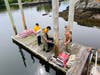Sea Cadets load a cart on the Pomham dock with top soil and concrete for the fence project.