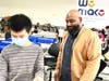 Moe Siddiqu, We Make's Executive Director checking in with staff member Steven Hu at We Make, Autism At Work.