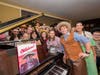 Some of the cast members of CBEast's performance of Rodgers and Hammerstein's "Oklahoma!" at the piano in the former residence of Oscar Hammerstein II.