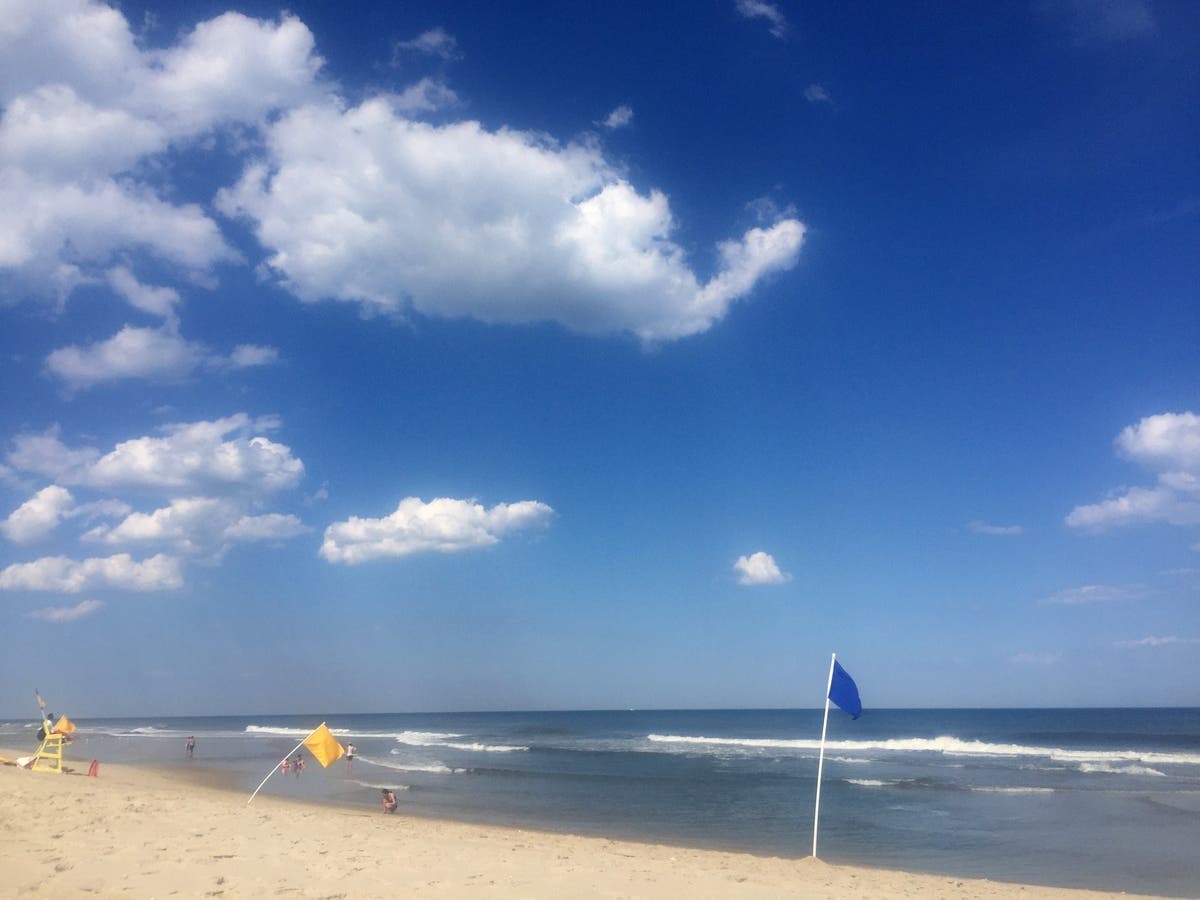 The swimmer, who was described as being in his 70s, was near the finish line when he was "spotted in distress," triathlon officials said.