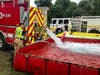 A firefighter empties his tanker into the pop-up pool, feeding water to crews on the remote scene. 