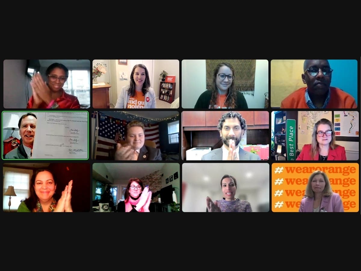 Anne Arundel County Executive Steuart Pittman (far left of the middle row) on Jan. 10 signed a law that requires gun dealers to distribute safety, mental health and conflict resolution information with each sale. 