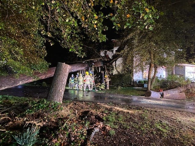 The Anne Arundel County Fire Department said a man is dead and a woman is hospitalized after a tree fell on a home near Annapolis during a Monday night storm. The damaged home is pictured above.