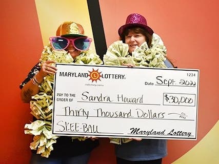 Arnold woman Sandra Howard (right) celebrates her $30,000 win on a Maryland Lottery scratch-off. Her adult daughter (left) also joined the fun.