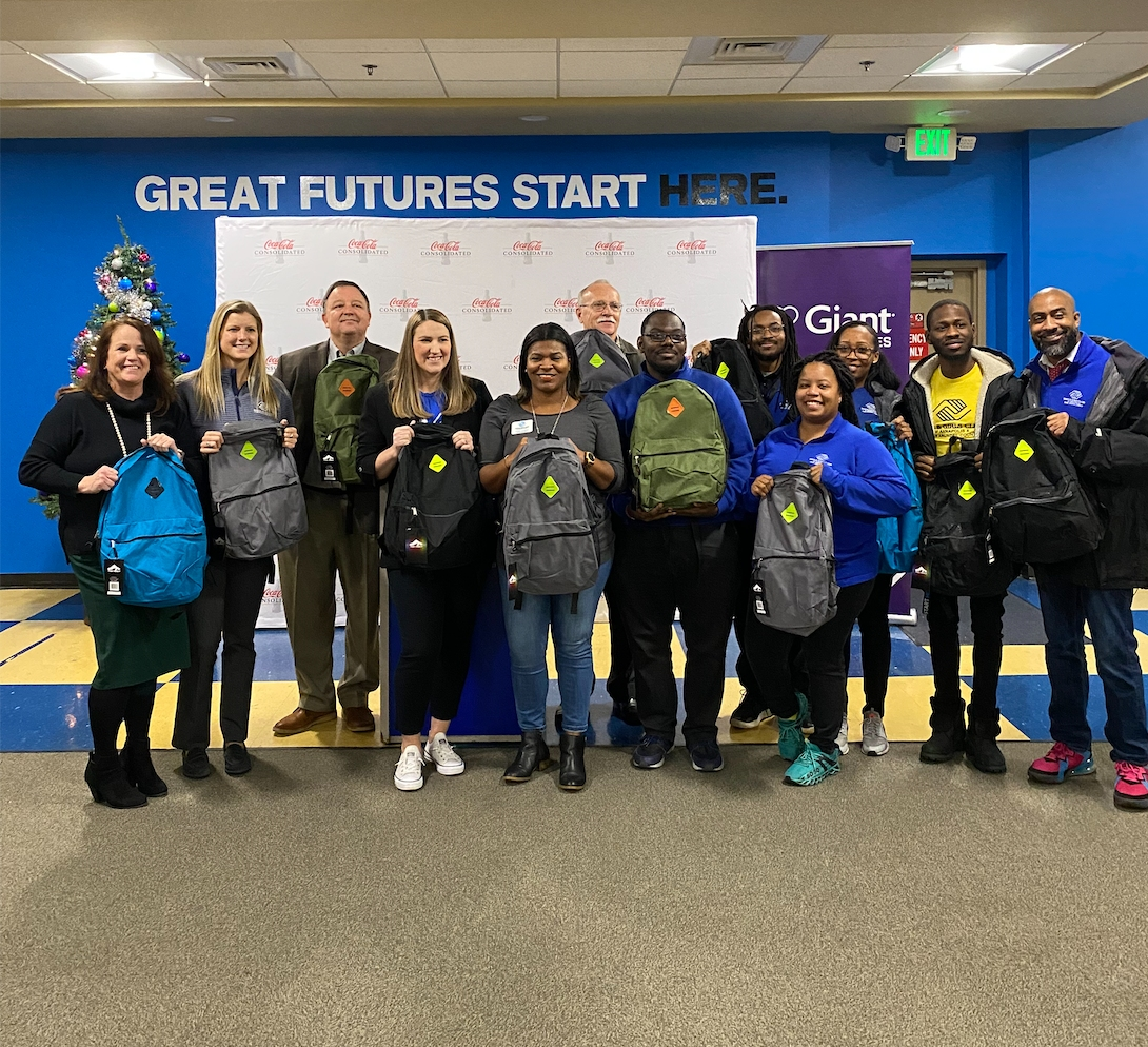 The Boys & Girls Clubs of Annapolis & Anne Arundel County on Dec. 15 welcomed a donation of $10,000 and 1,000 backpacks stuffed with food. The gift came from Coca-Cola Consolidated and Giant Food. The group is pictured above during the event.