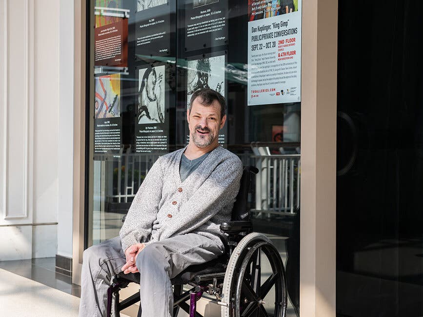 Dan Keplinger ’98, ’03, ’07 visits the exhibition of his work at Towson Town Center. “Public/Private Conversations” spans two decades of Keplinger’s work.
